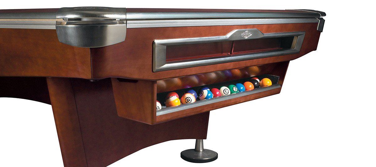 Brown pool table with balls in the rack and a built-in ball return slot