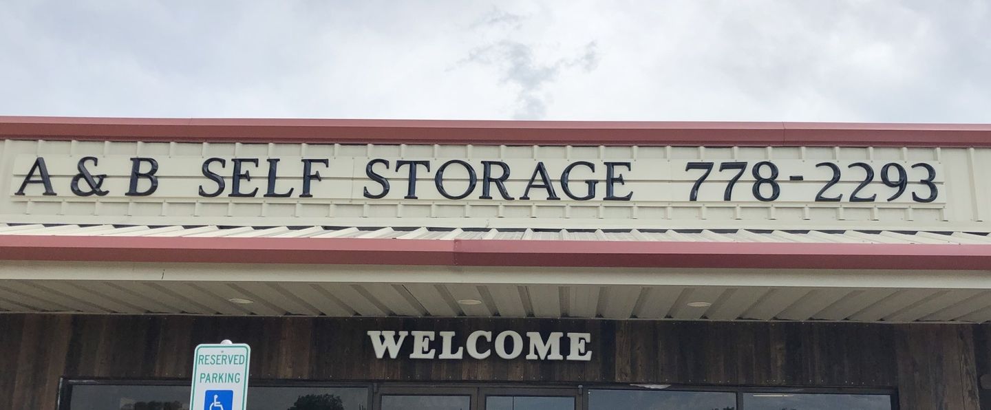 Image of front of Storage office building that has a welcome sign and the storage number 9797782293