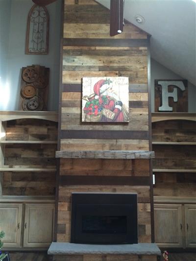 A fireplace with a painting above it and a letter f on the wall