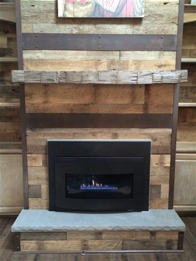 A wooden fireplace with a painting above it