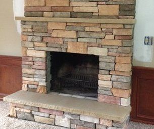 A stone fireplace in a living room with the number 0 on the wall