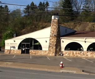 A white building with arches and a fire hydrant in front of it