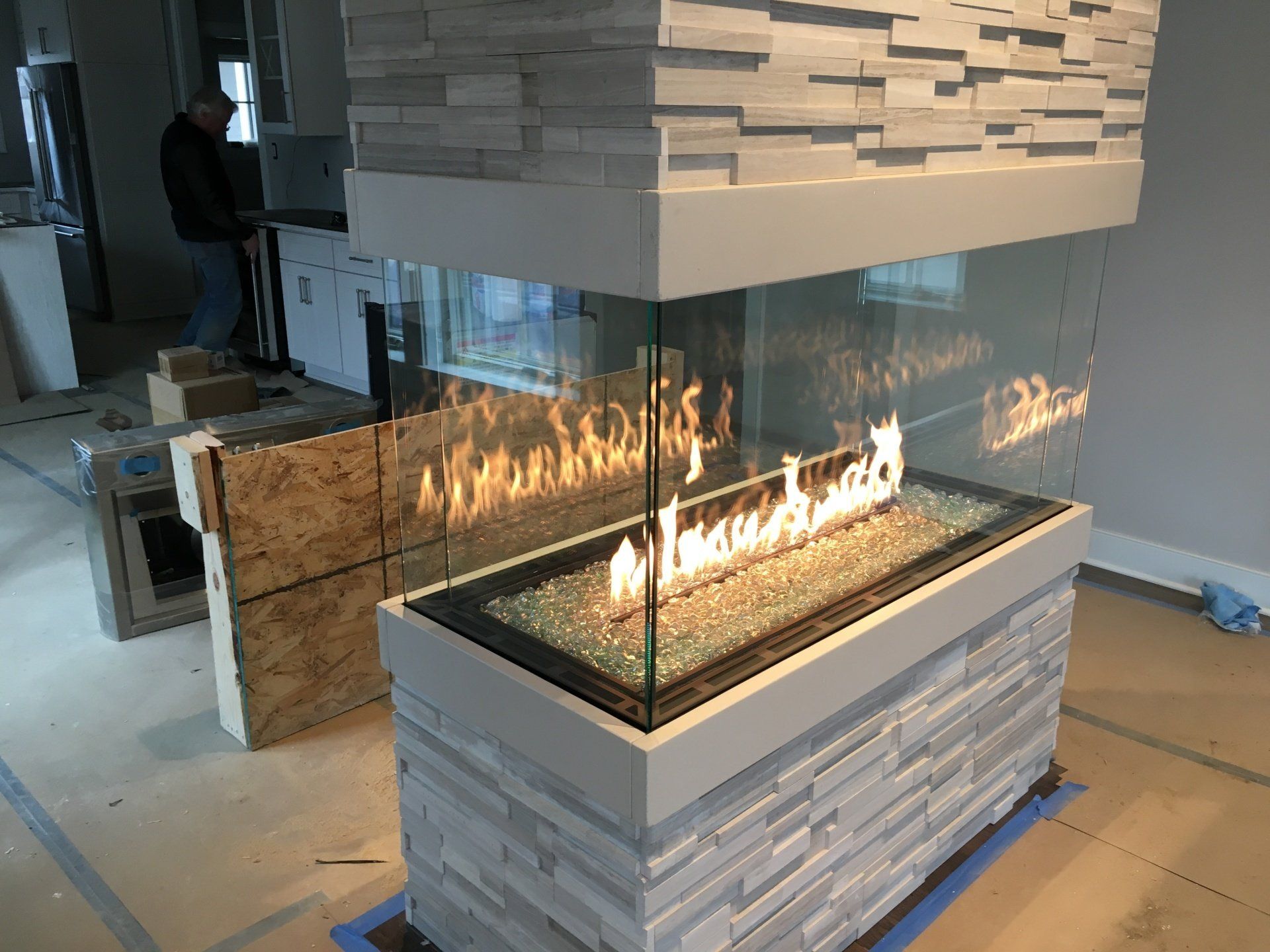 A fireplace is being built in a room in a house.