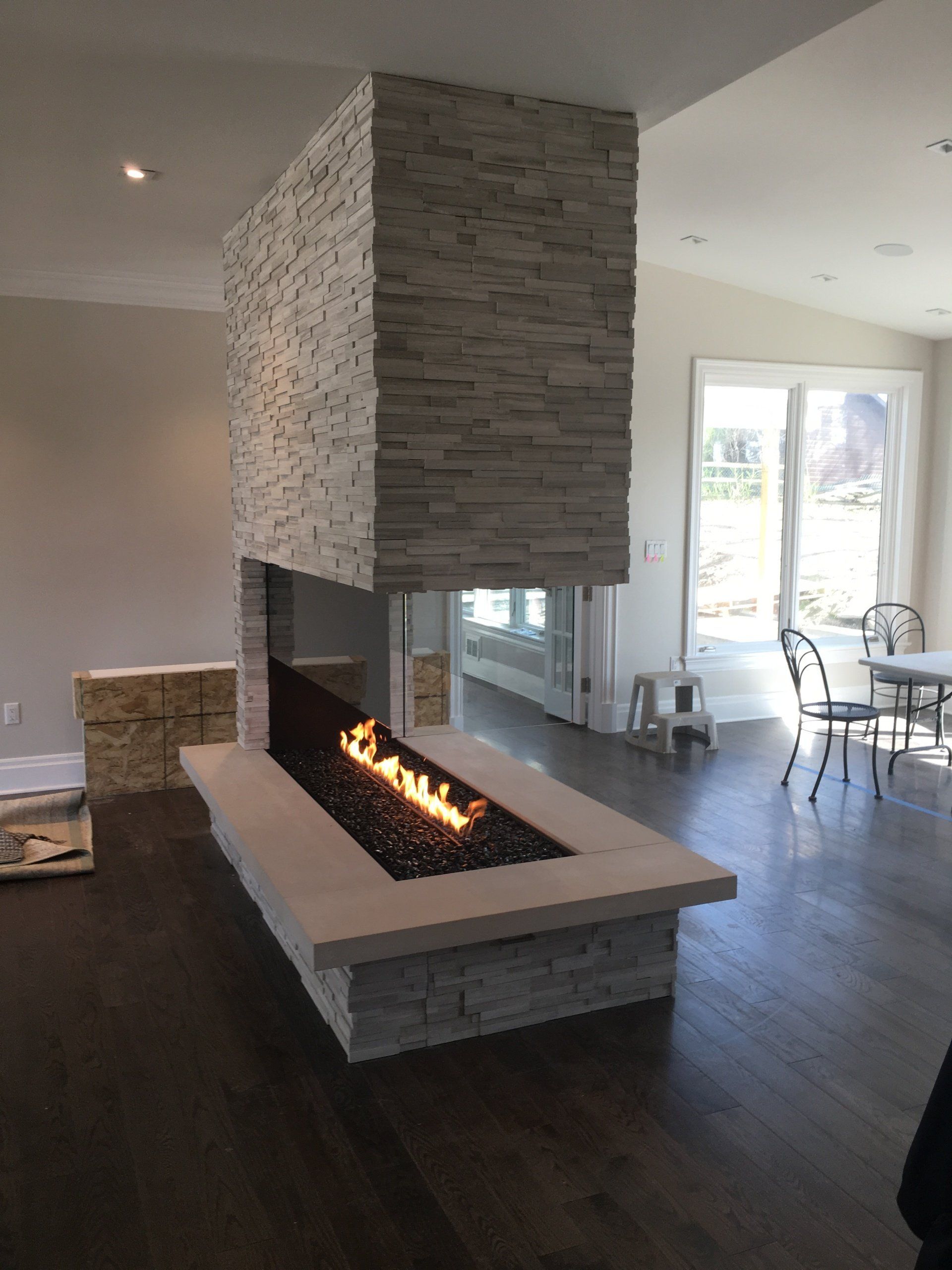 A living room with a fireplace in the middle of it