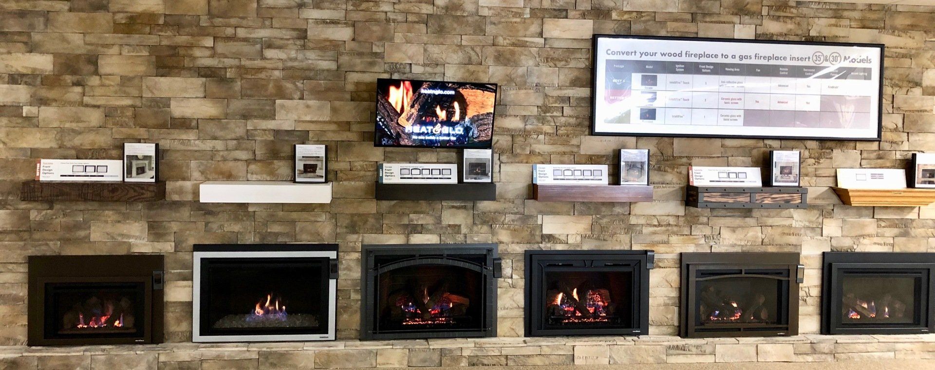 There are many different types of fireplace inserts on the wall.