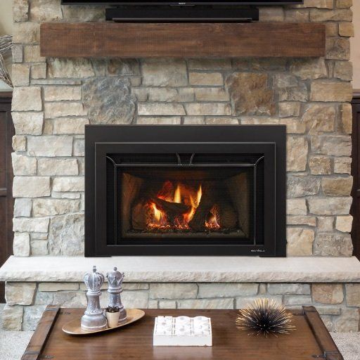 A fireplace with a tv above it and a wooden mantle