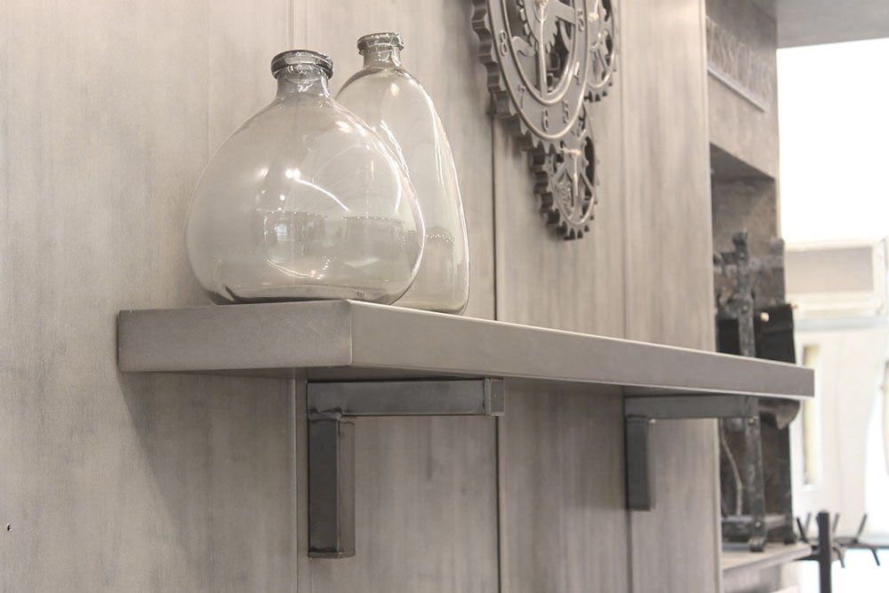 A shelf with two vases on it and a clock on the wall behind it.