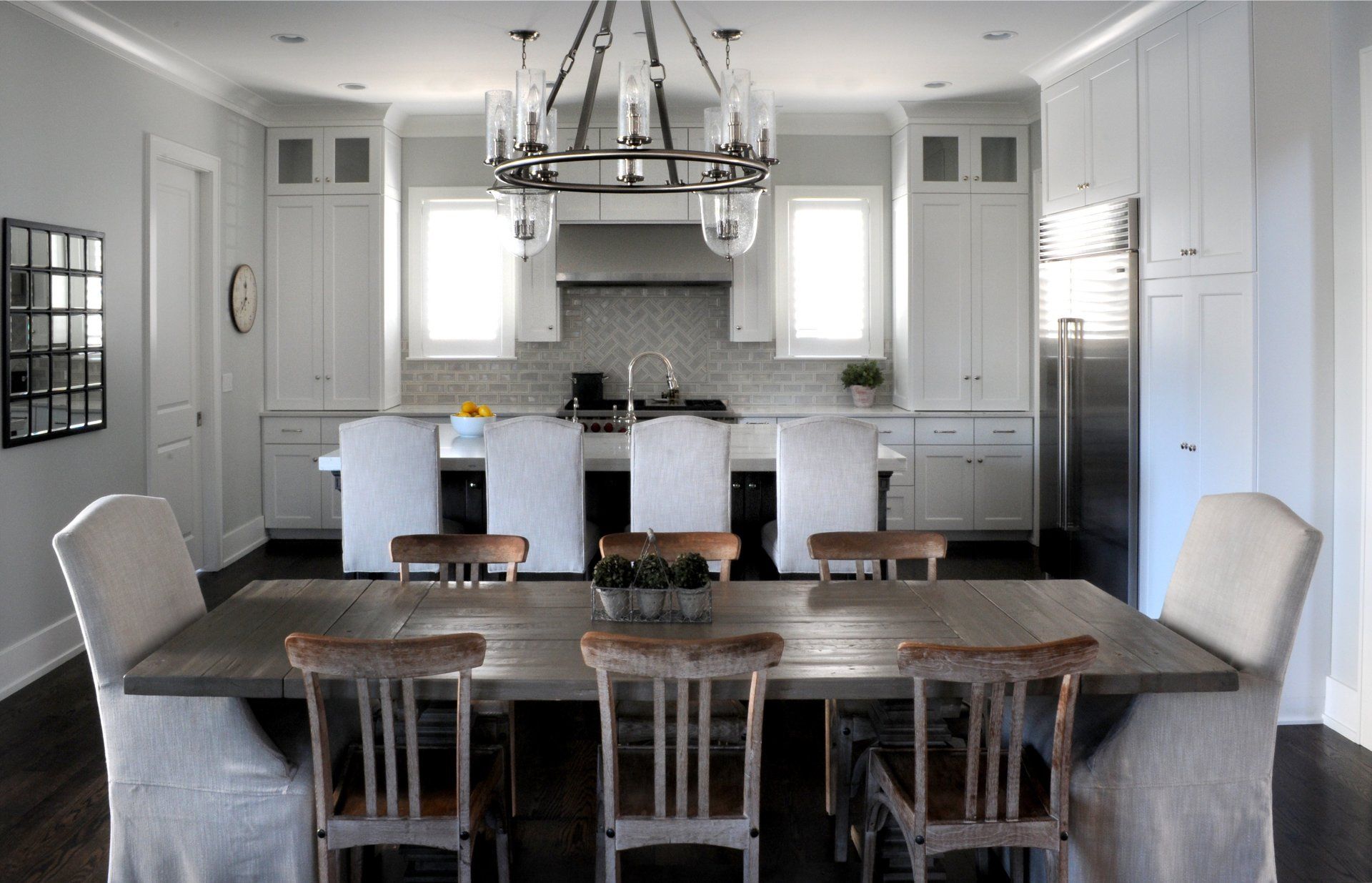 A kitchen with a table and chairs and a chandelier