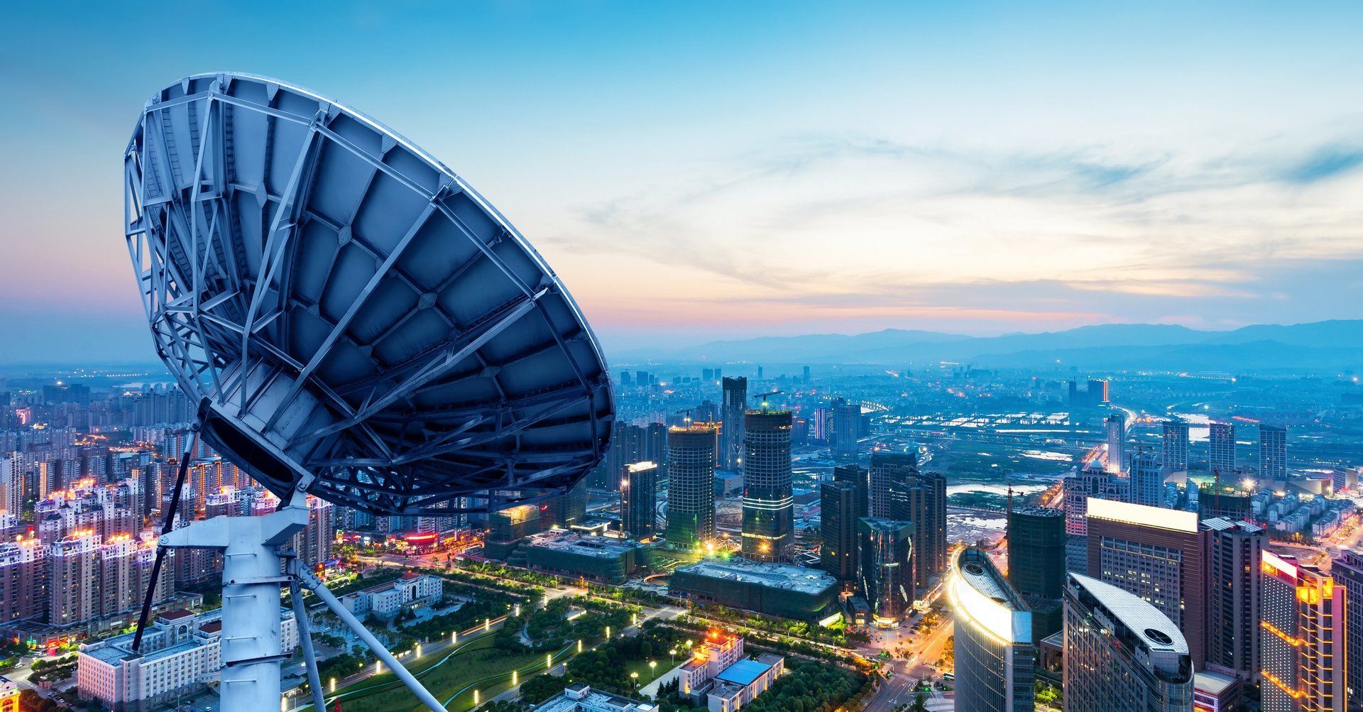 a large satellite dish is sitting in the middle of a city .
