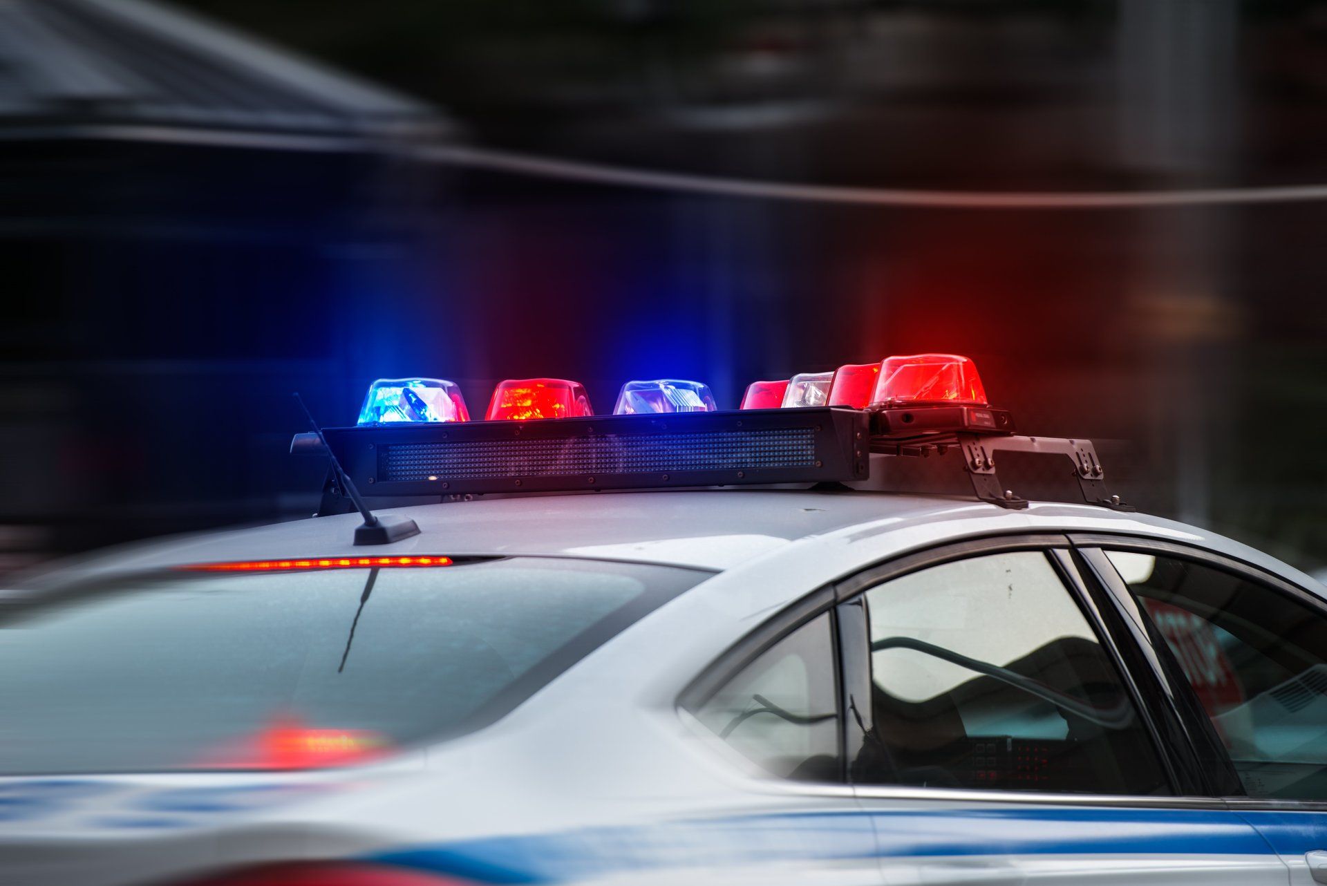 a police car with red and blue lights on top of it .