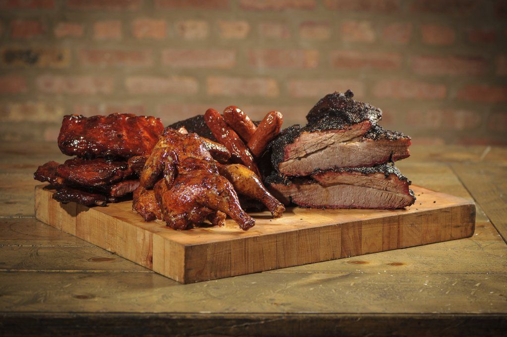 there are many different types of meat on the cutting board .