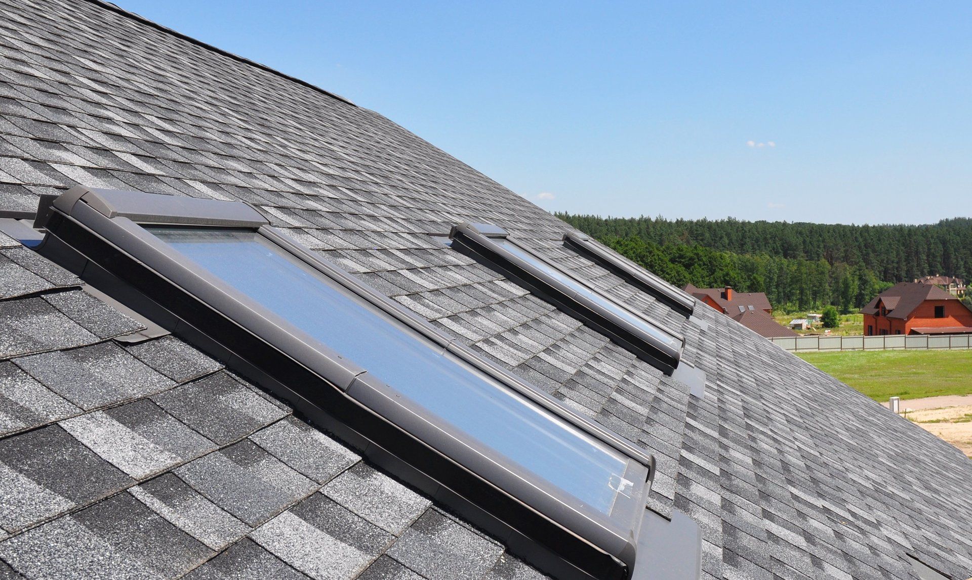there are two skylights on the roof of a house .