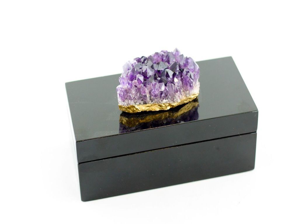 a black box with a purple crystal on top of it .