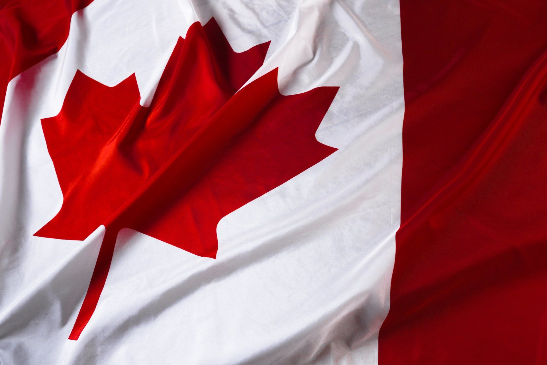 A canadian flag with a red maple leaf on it