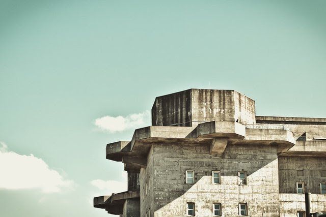 a large concrete building with a blue sky in the background .