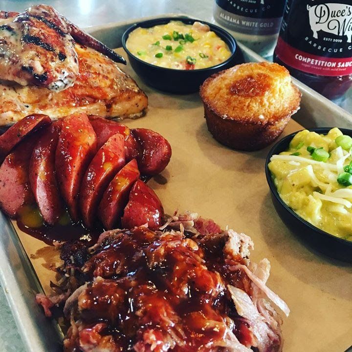A tray of food including sausage and mashed potatoes