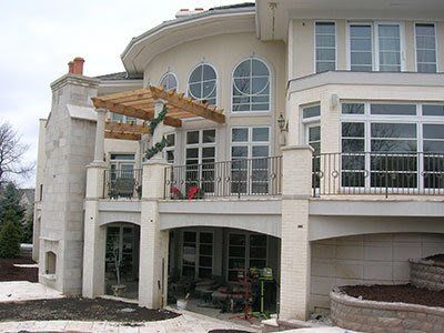 A large white house with lots of windows and a balcony