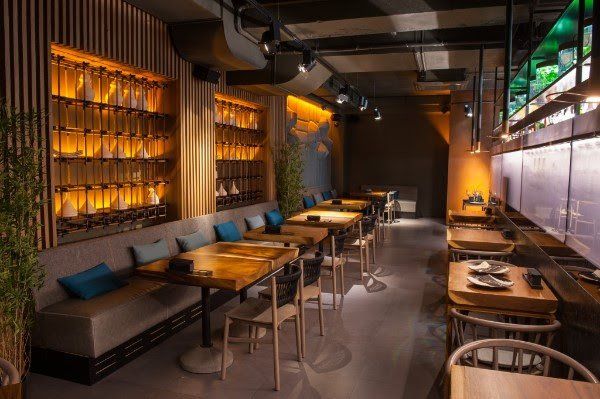 A restaurant with tables and chairs and a couch.