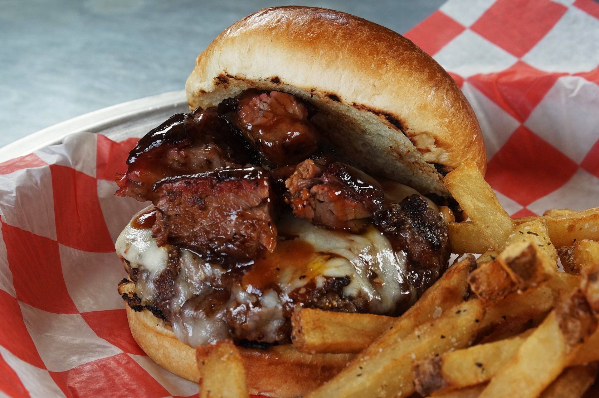 a hamburger and french fries on a checkered paper