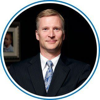 A man in a suit and tie is in a blue circle