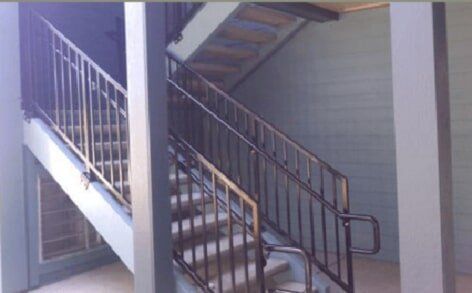 Stairs with metal handrails — Fence Contractors & Builders in Springfield, OR Stairs with metal handrails — Fence Contractors & Builders in Springfield, OR