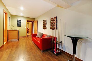 finished basement room with hardwood floor and recessed lighting