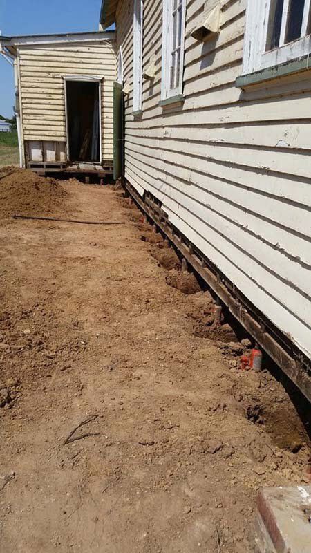 house with dirt side yard