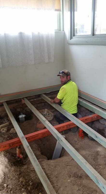 man standing in house foundation