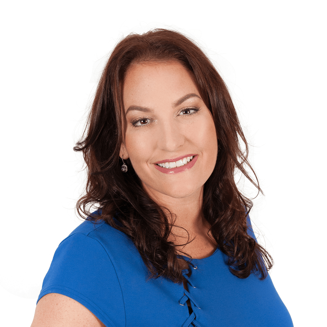 A woman in a blue shirt is smiling for the camera.
