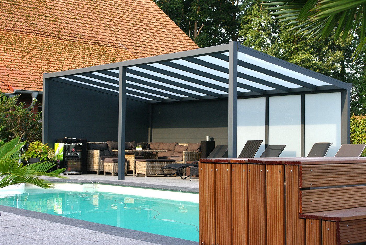 Im Hinterhof gibt es einen Swimmingpool mit einer Pergola darüber.
