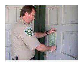 Man Posting Note on the Door - Landlord Eviction in Beverly Hills, CA
