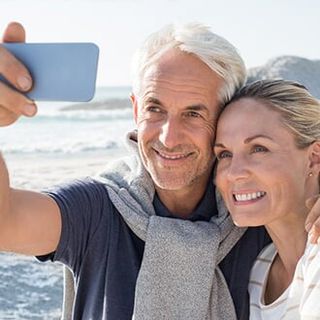 Senior Couple Taking Selfie — Medicare Plans in Bozeman, MT Senior Couple Taking Selfie — Medicare Plans in Bozeman, MT