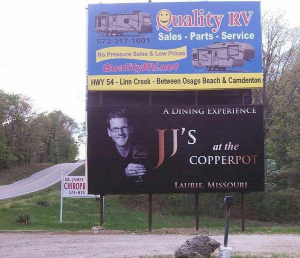 a billboard advertising jj 's at the copperpot in laurie missouri