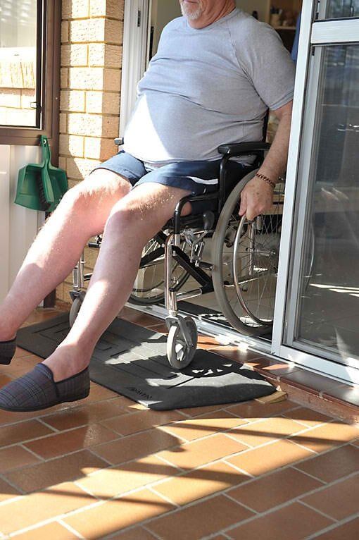 Man in Wheelchair Getting Out from the Door — Home Modification Services In Byron Bay, NSW
