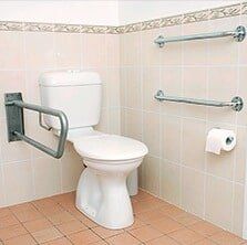 Toilet With Handrails — Home Modification Services In Byron Bay, NSW