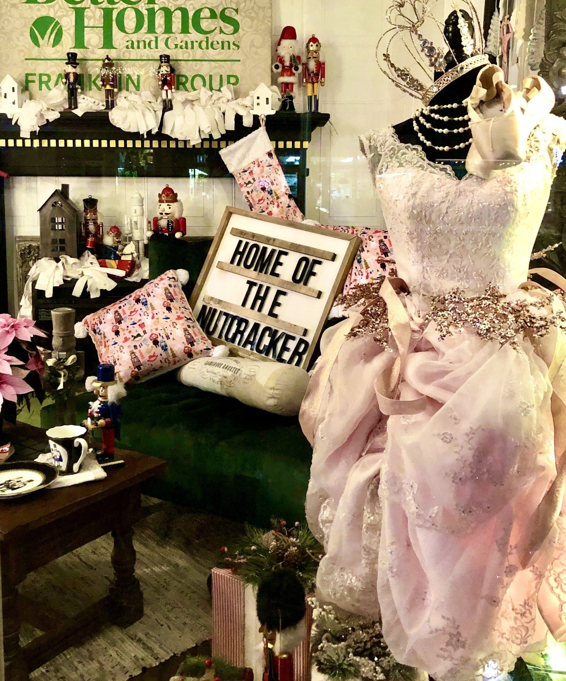 A pink dress with a sign that says home of the nutcracker