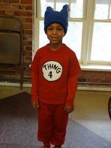 A young boy is wearing a thing 4 costume