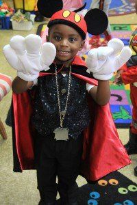 A young boy dressed in a mickey mouse costume