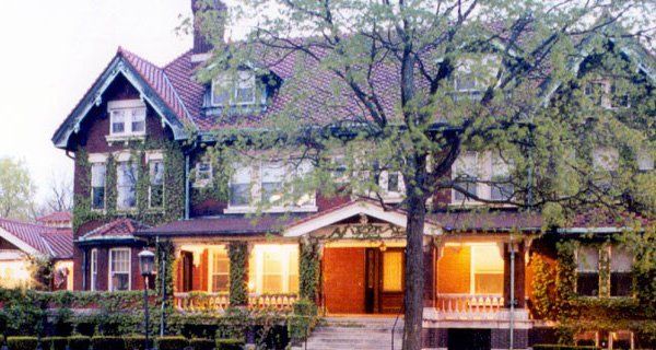 A large house with a tree in front of it