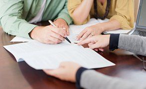 A couple, signing a document