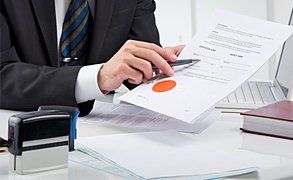 A man in a suit explaining a document