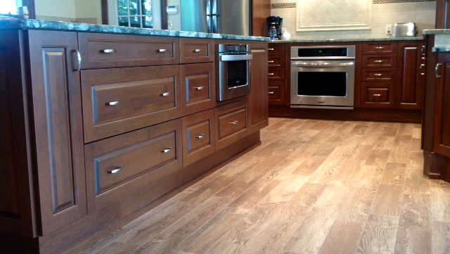 A kitchen with wooden cabinets and stainless steel appliances