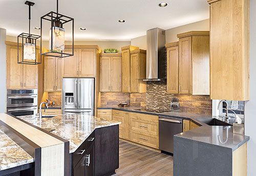 A kitchen with stainless steel appliances and wooden cabinets