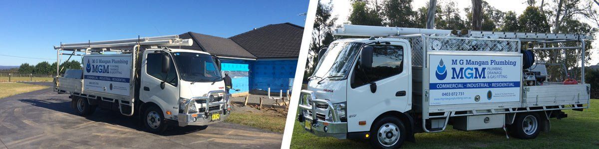 mg mangan plumbing two trucks
