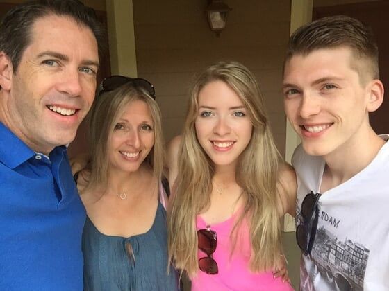 group of four individuals smiling together.
