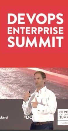 Scott Potter presenting on stage at the Dev Ops Enterprise Summit. devops transformation.
