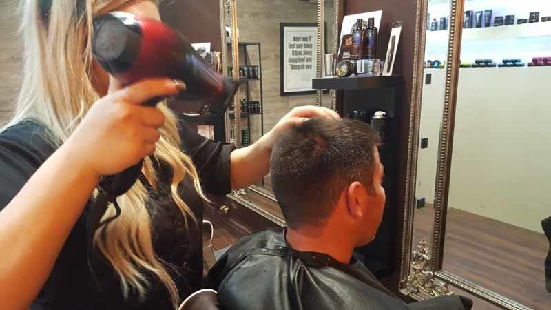 woman using hair dryer