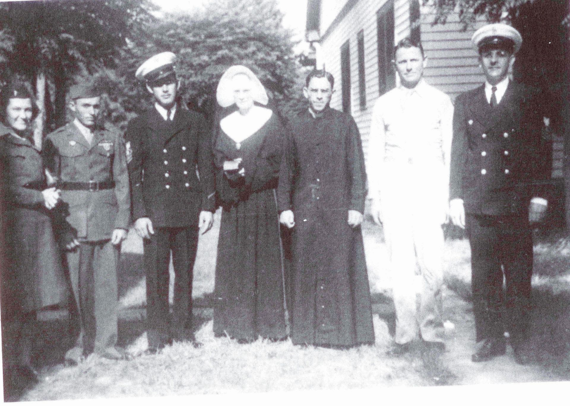Returning World War II heroes wre welcomed home in 1945 by Father Bernard and Sister Theophilus. From left: •Captain Marie Elbie Robin, USAF, R.N., served in hospitals in the Philippines, Japan, Wales, France and stateside. •Sgt. Clement Bourque, U.S. Marines, served in the 4th Marine Division in the Pacific: Iwo Jima, Saipan and Tinyan. He was awarded the Bronze Star and the Purple Heart. •Chief Bosun's Mate Wilbur Kidder, U.S. Navy, served on a ship in the South Pacific. •Sgt. William Wiltz, U.S. Army was an electronic systems expert. He set up base electrical systems on bases in Utah, Colorado, Arkansas, Witchita Falls and Alexandria, Louisiana. He was drafted in 1944. •Chief Petty Officer James Carroll Darby, U.S. Navy, a chief pharmacist mate, served on the Navy Torpedo Boat base medical dispensary in the South Pacific. He was on the medical team that treated John F. Kennedy's injuuries when his PT-109 boat was destroyed,