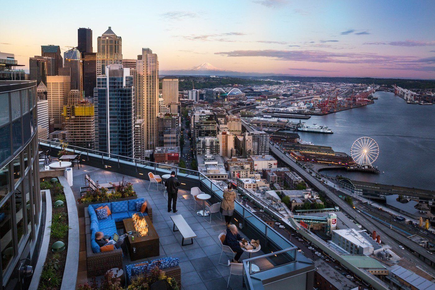 An aerial view of a city with a ferris wheel in the distance.