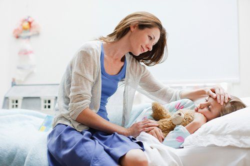 Family And Medical Leave — Mother Checking On Sick Daughter in Huntsville, AL Family And Medical Leave — Mother Checking On Sick Daughter in Huntsville, AL